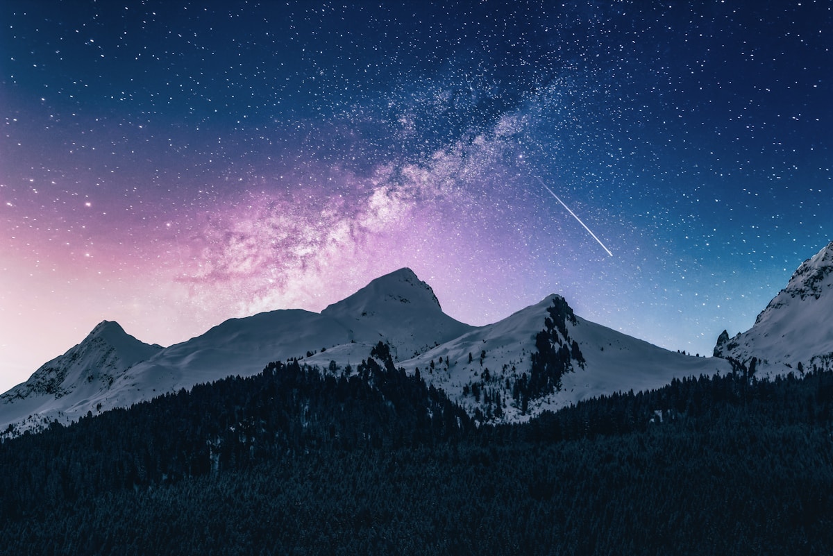 Starry night over snow-covered mountains