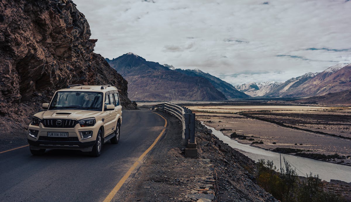 SUV on a scenic mountain road in Northeast India
