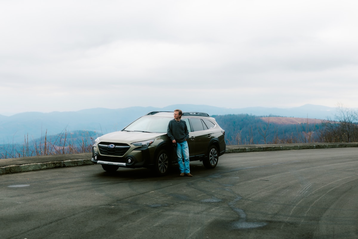 Travellers enjoying a mountain road trip with an SUV